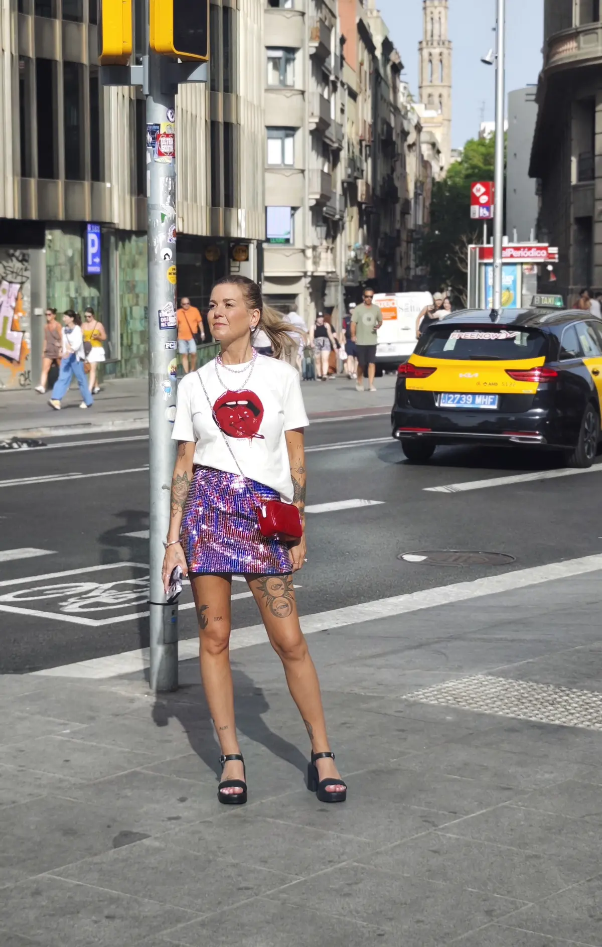 Cortnie Kairos at a Barcelona street crossing in a red lips tee